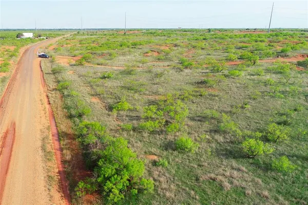 a view of a road with a yard