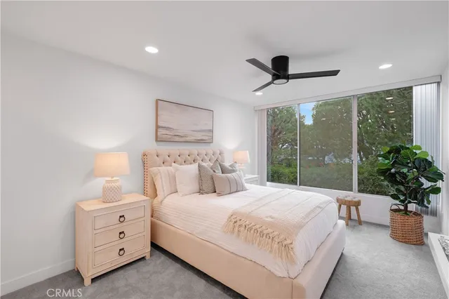 a bedroom with a large bed and a fireplace