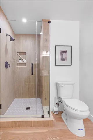 a bathroom with a sink a mirror and a potted plant