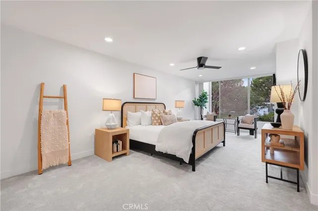 a bedroom with bed and a large window