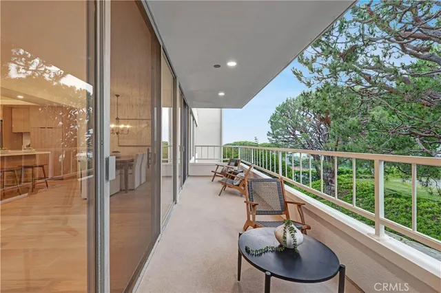 a view of a hallway and a livingroom with furniture