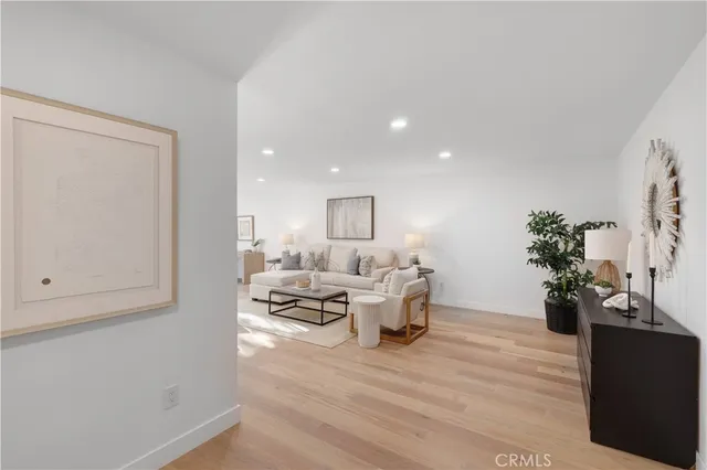 a living room with furniture and flowers