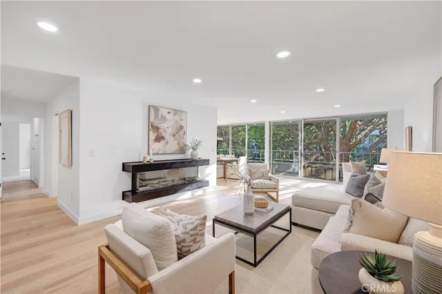 a living room with furniture and a floor to ceiling window