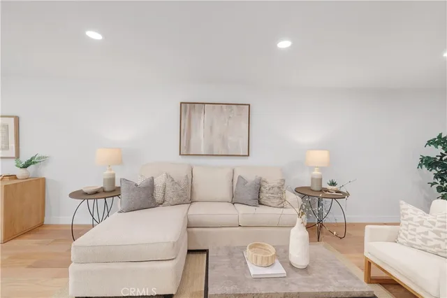 a living room with furniture a lamp and a potted plant