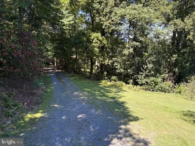 an empty room with a window and a chandelier fan