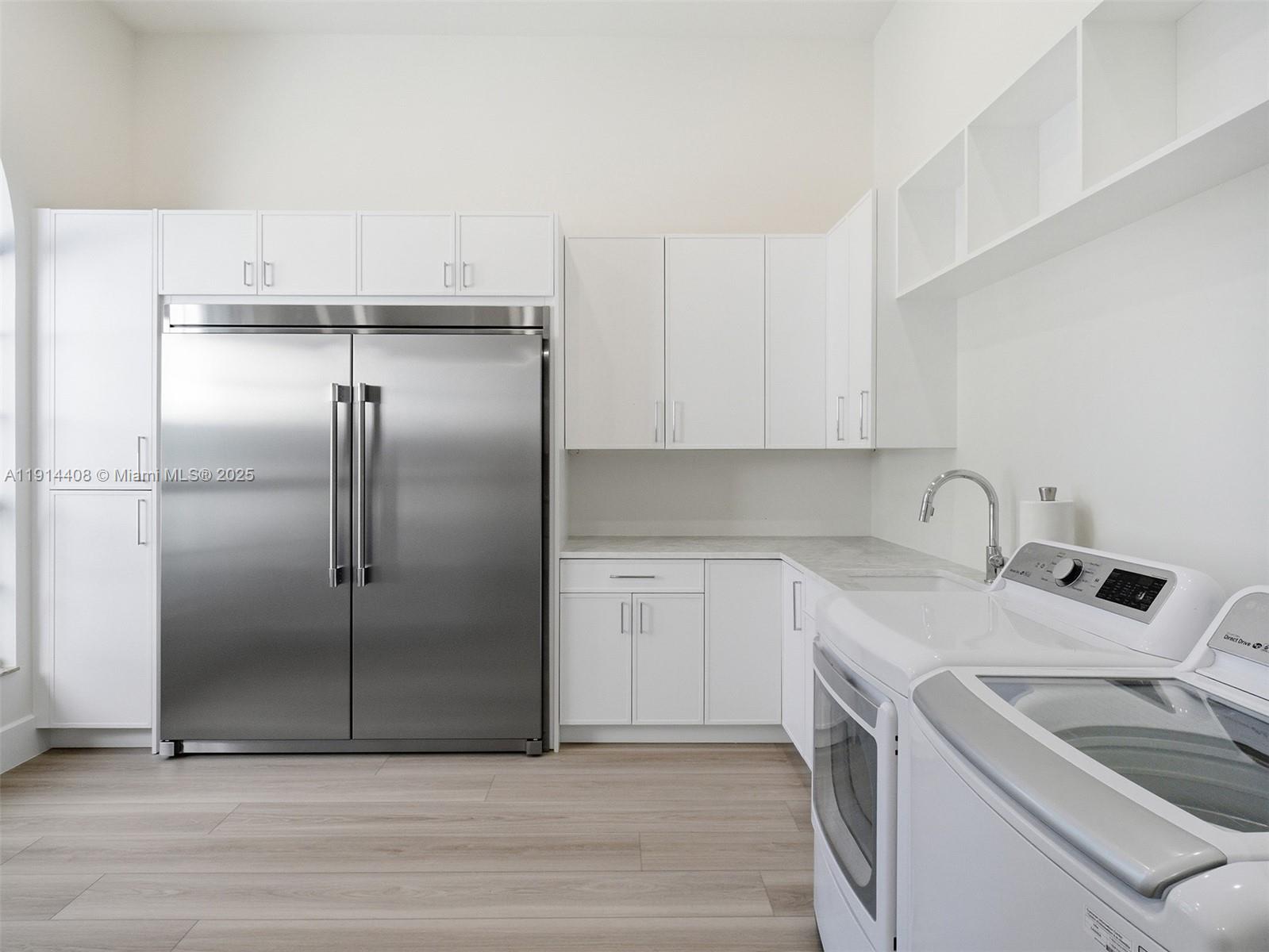 7675 Steeplechase Drive Palm Beach Gardens, FL 33418 - Photo 16 of 36 a kitchen with a refrigerator sink and cabinets
