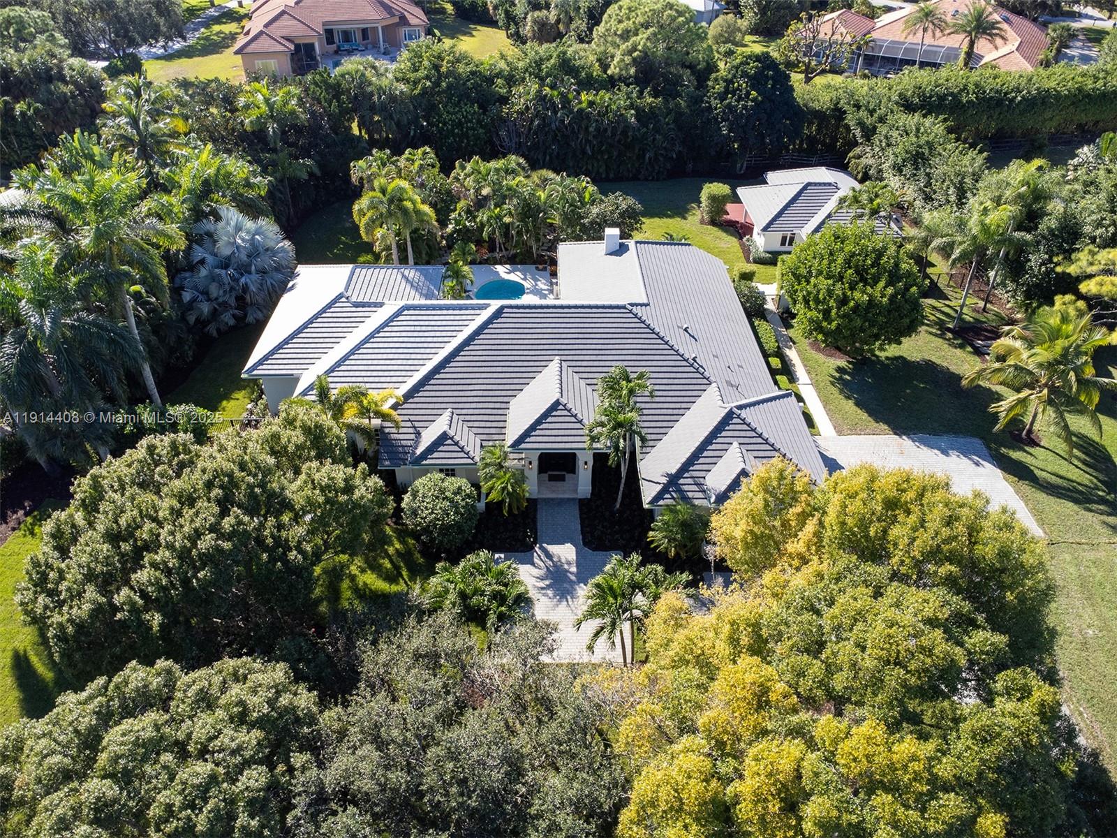 7675 Steeplechase Drive Palm Beach Gardens, FL 33418 - Photo 2 of 36 an aerial view of a house with a garden