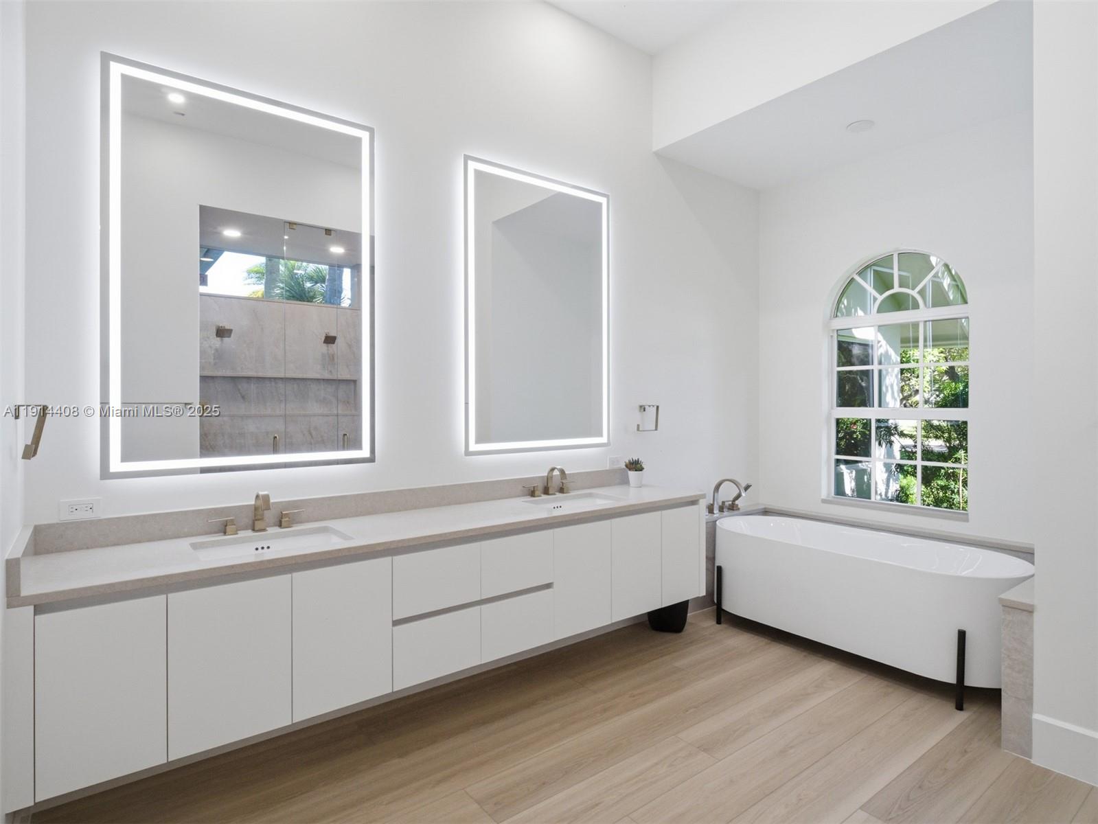 7675 Steeplechase Drive Palm Beach Gardens, FL 33418 - Photo 21 of 36 a bathroom with a double vanity sink and a bathtub