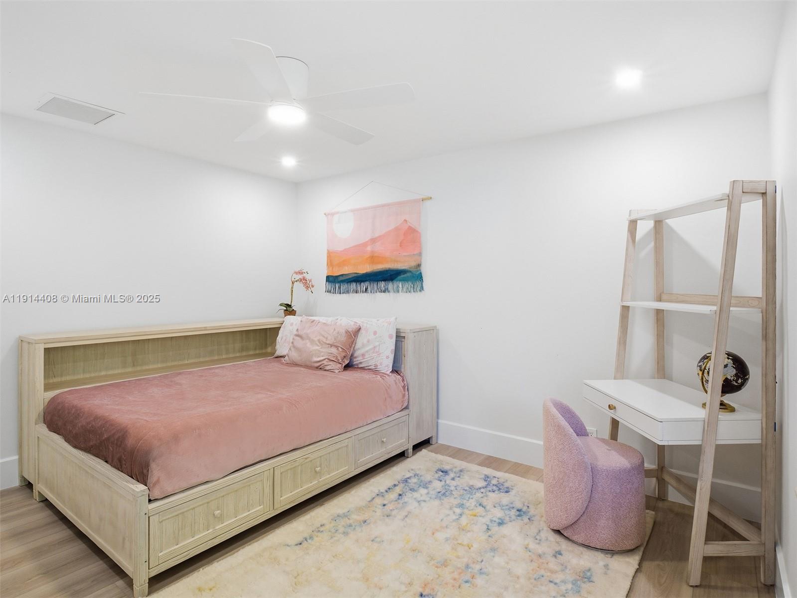 7675 Steeplechase Drive Palm Beach Gardens, FL 33418 - Photo 24 of 36 a bedroom with a bed and a couch