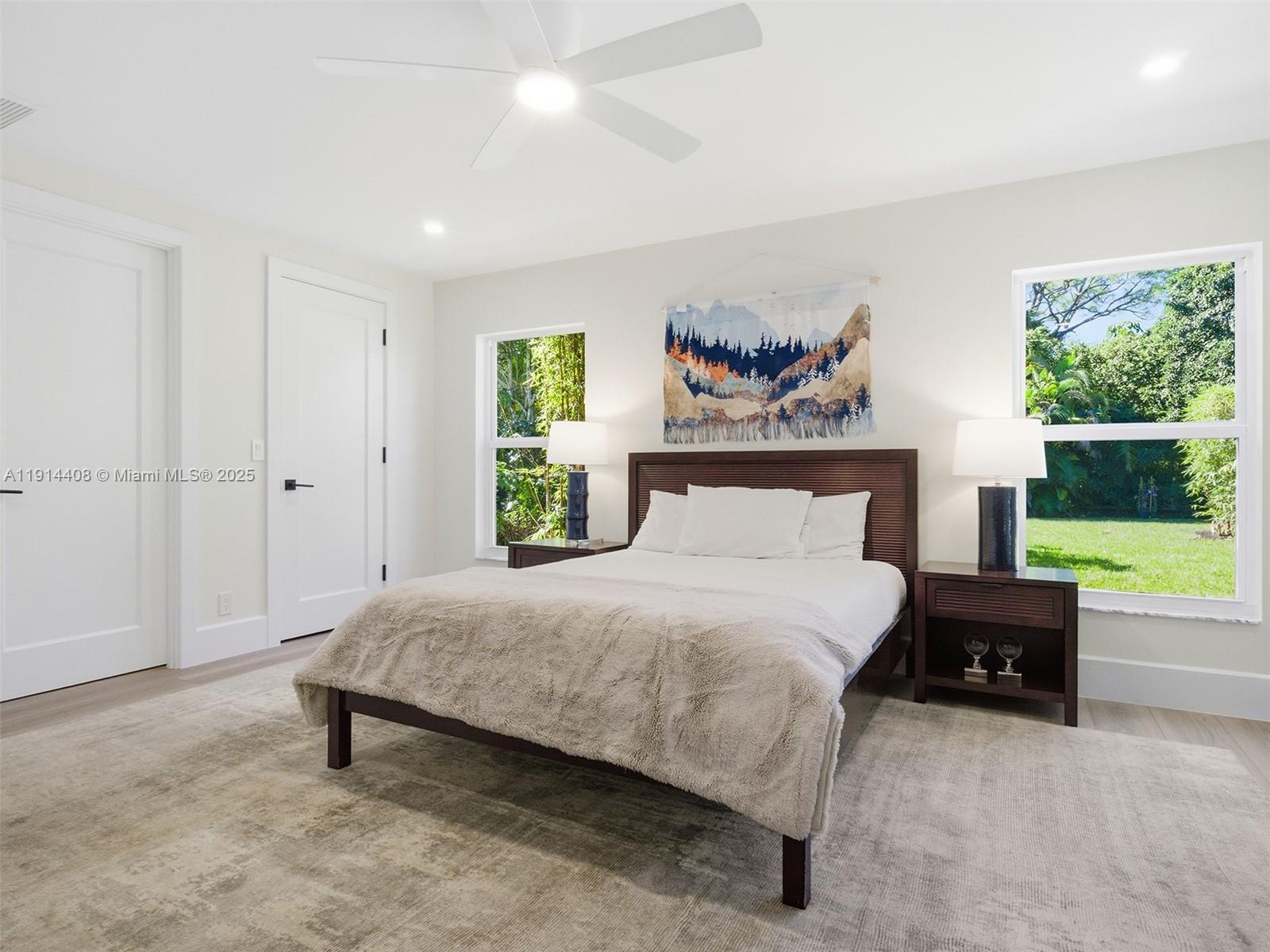 7675 Steeplechase Drive Palm Beach Gardens, FL 33418 - Photo 25 of 36 a bedroom with a bed and a couch