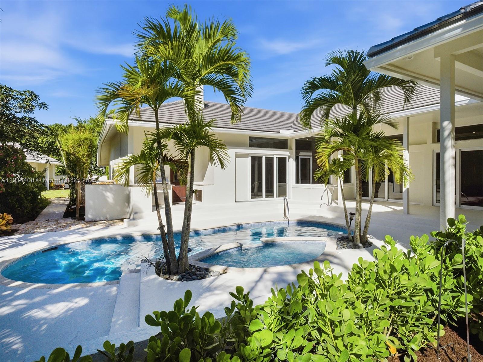 7675 Steeplechase Drive Palm Beach Gardens, FL 33418 - Photo 27 of 36 a vase of flowers sitting on a table in front of a house