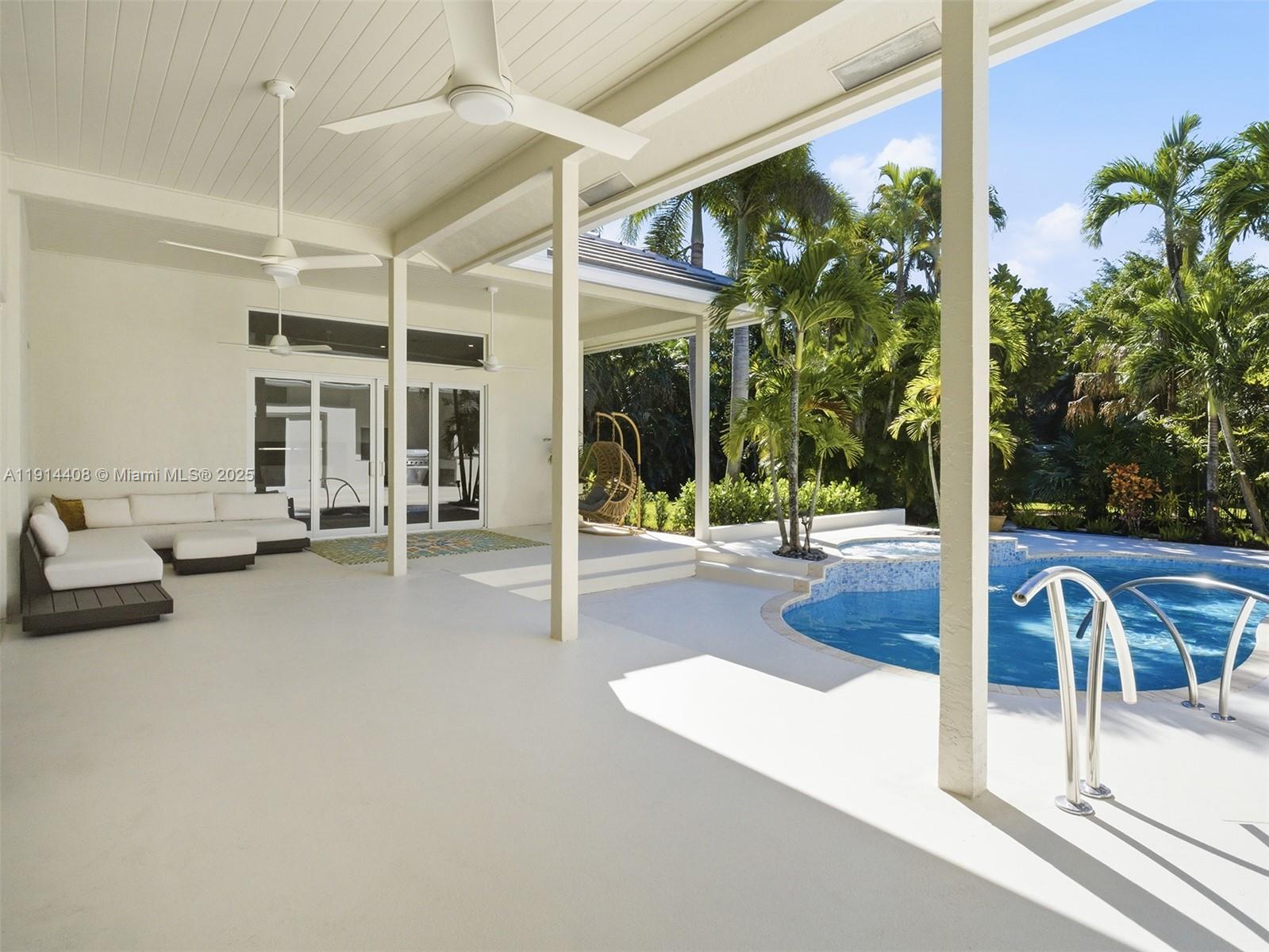 7675 Steeplechase Drive Palm Beach Gardens, FL 33418 - Photo 29 of 36 a swimming pool with outdoor seating and yard