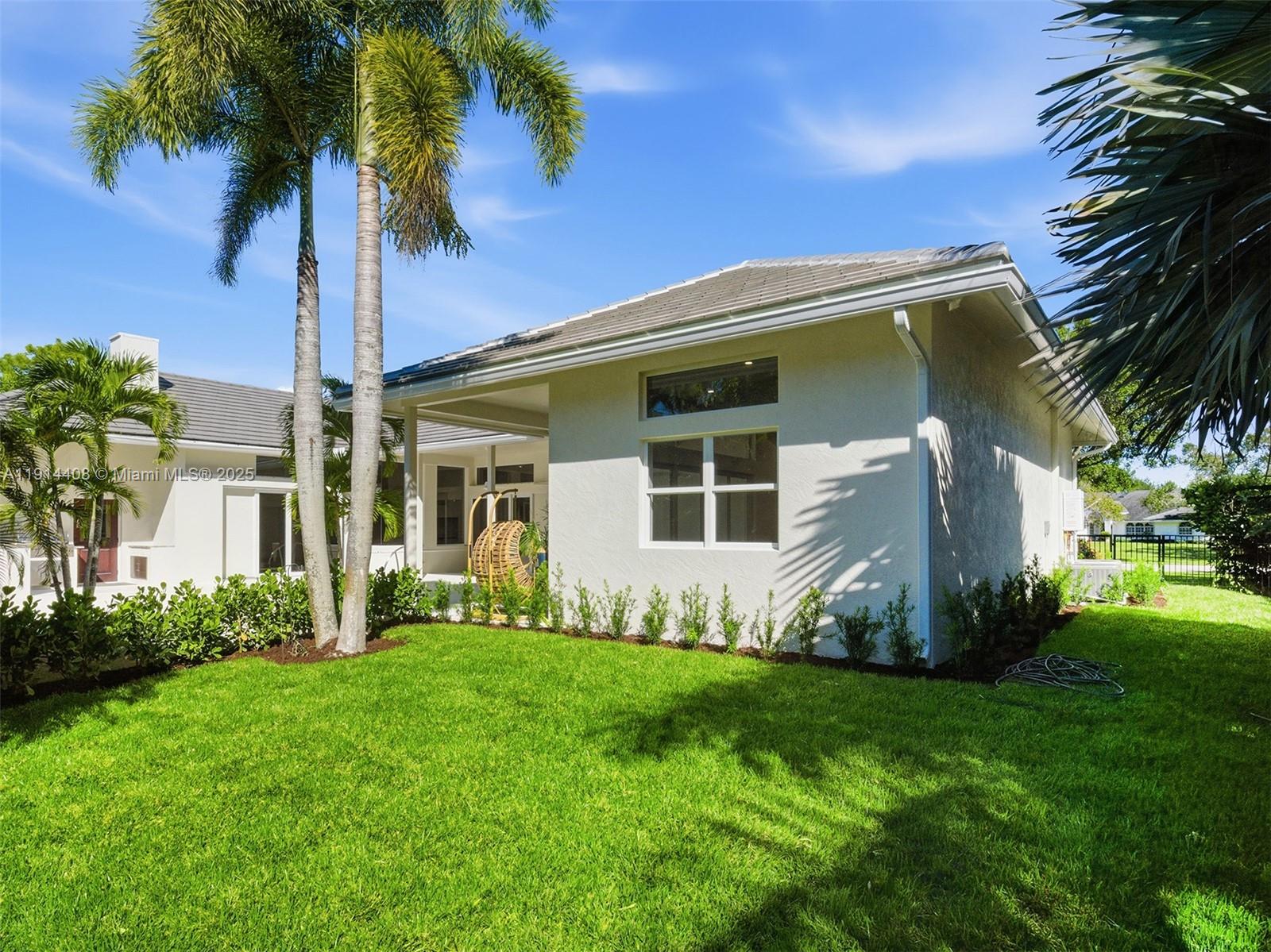 7675 Steeplechase Drive Palm Beach Gardens, FL 33418 - Photo 30 of 36 a front view of a house with garden
