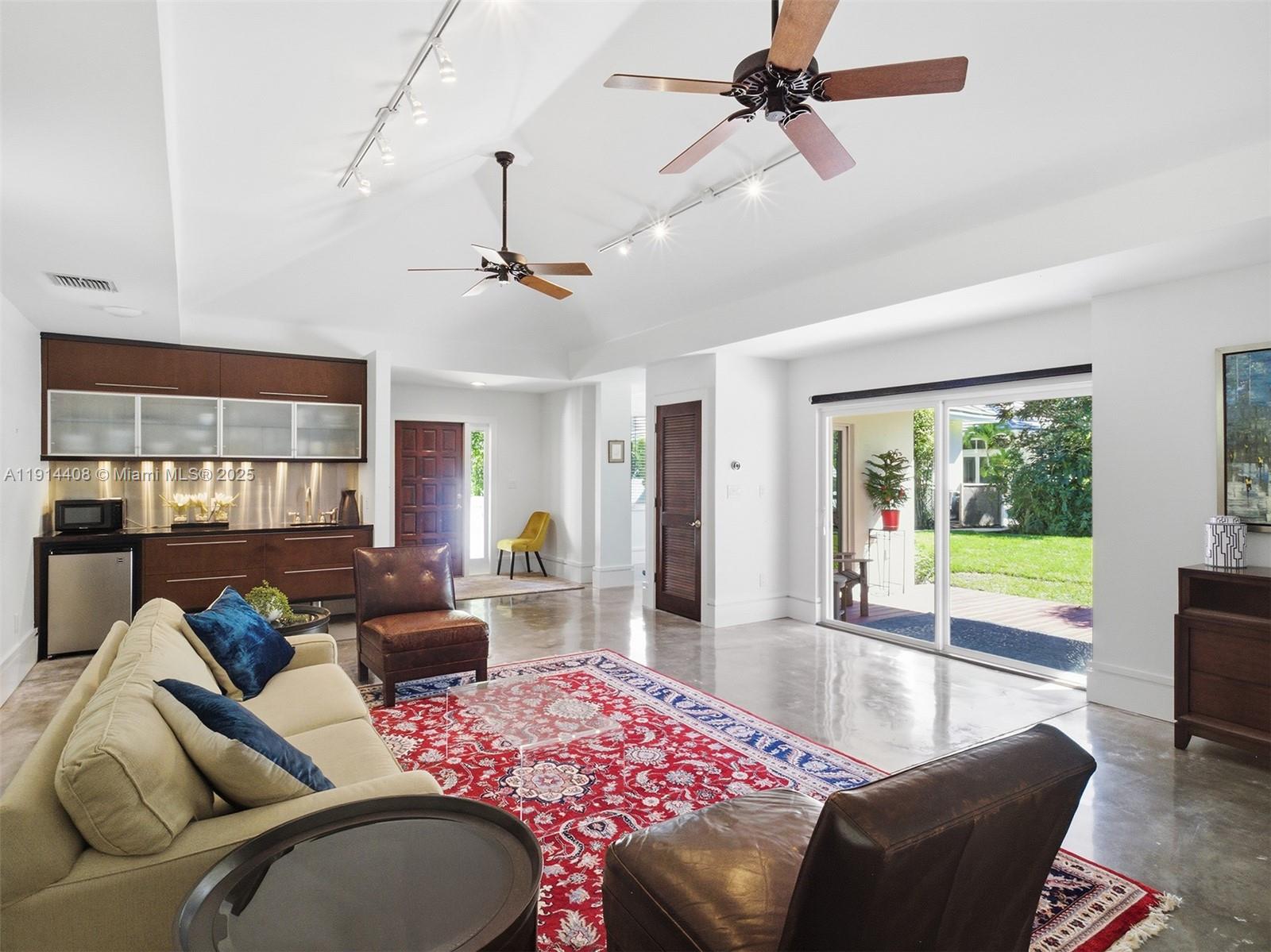7675 Steeplechase Drive Palm Beach Gardens, FL 33418 - Photo 33 of 36 a living room with furniture and a large window