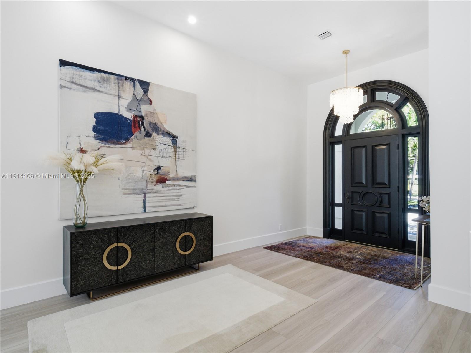 7675 Steeplechase Drive Palm Beach Gardens, FL 33418 - Photo 6 of 36 a view of a livingroom with a washer and dryer
