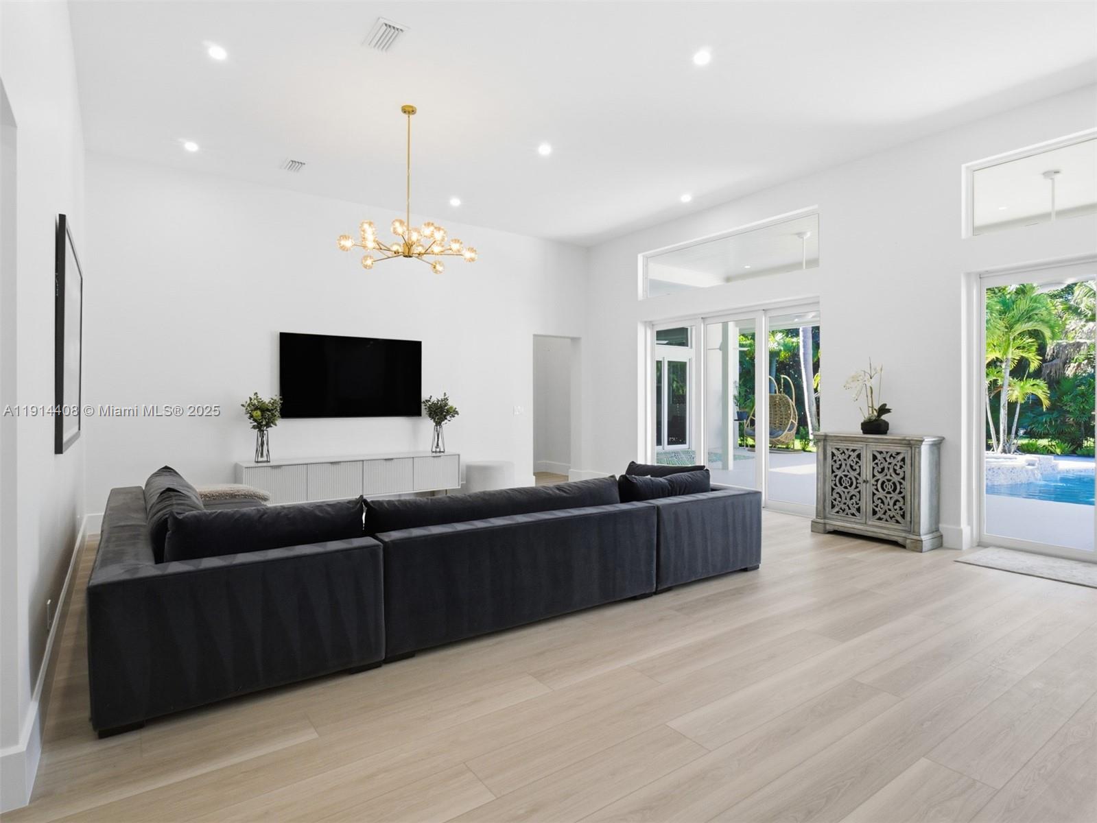 7675 Steeplechase Drive Palm Beach Gardens, FL 33418 - Photo 8 of 36 a living room with furniture and a flat screen tv