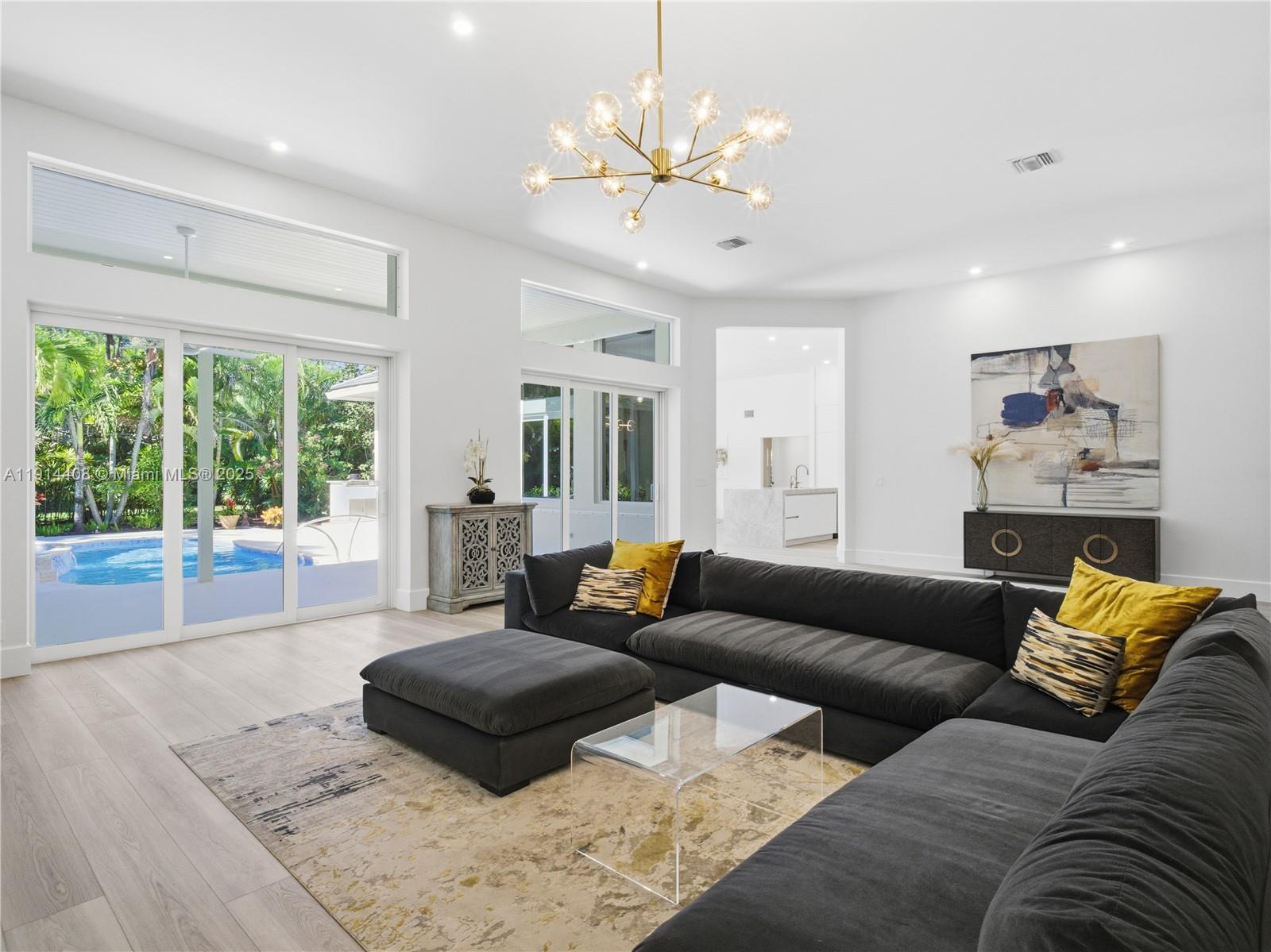 7675 Steeplechase Drive Palm Beach Gardens, FL 33418 - Photo 9 of 36 a living room with furniture and a large window