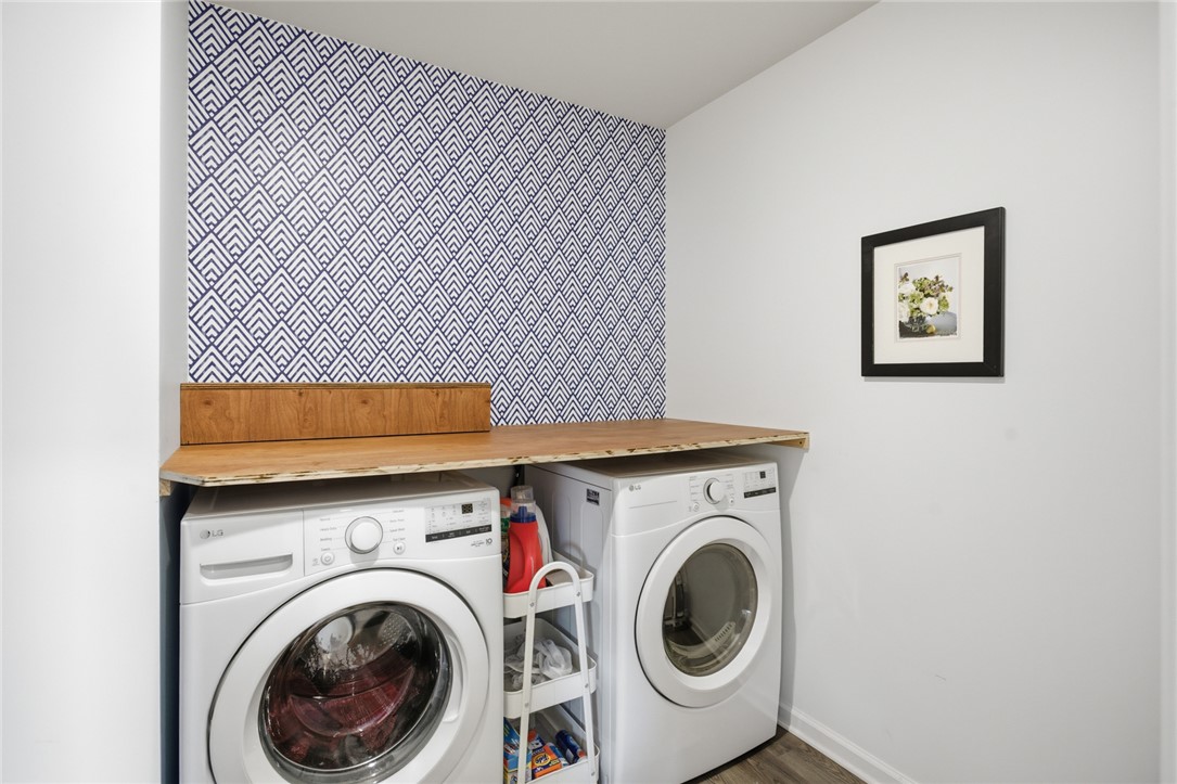 412 Chadwick Lane Walhalla, SC 29691 - Photo 12 of 37 Functional laundry space includes front-loading appliances, a practical wooden countertop, and patterned accent wall.