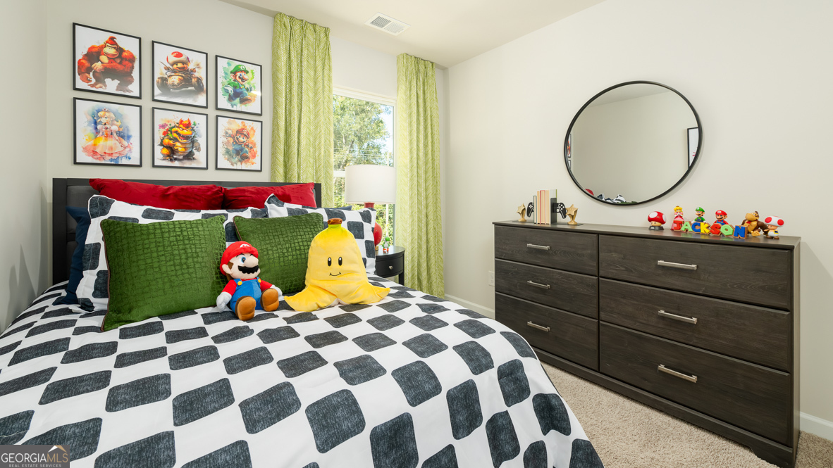 2080 Moss Hill Road Stone Mountain, GA 30088 - Photo 35 of 39 a bed room with a bed a dresser and a painting on the wall