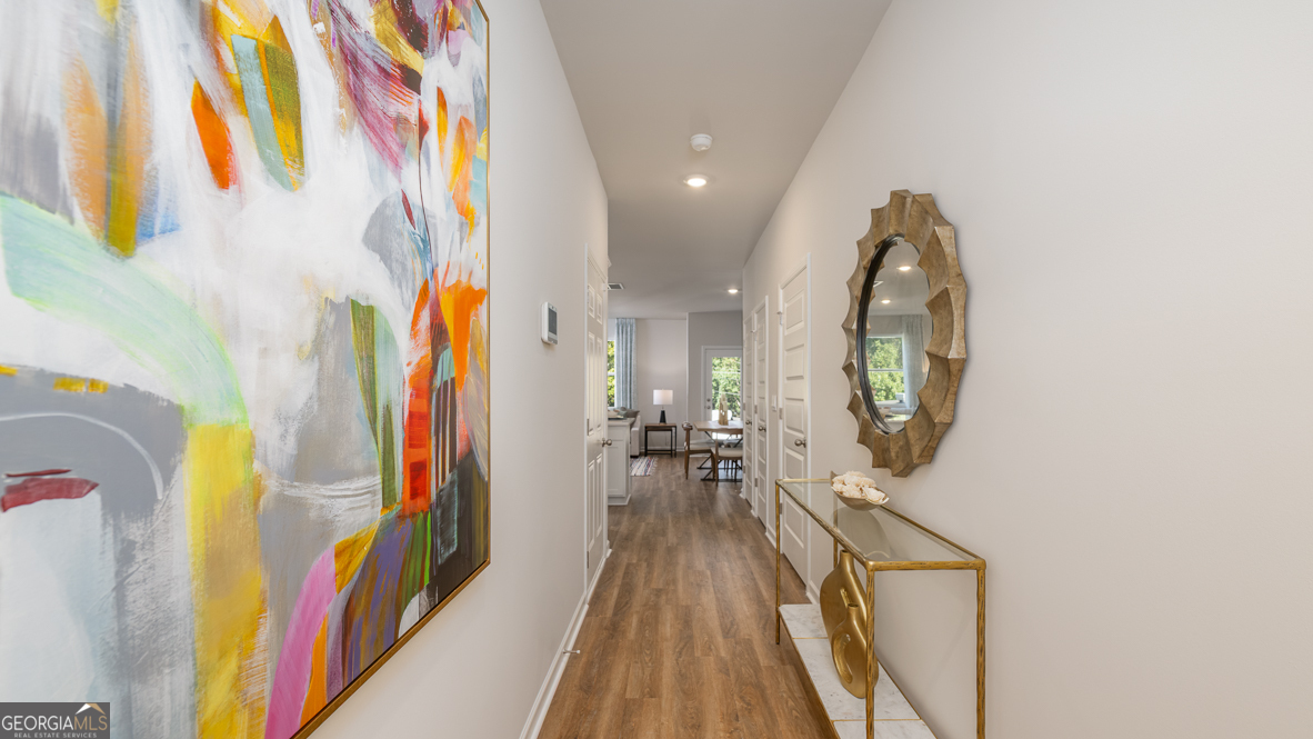 2080 Moss Hill Road Stone Mountain, GA 30088 - Photo 10 of 39 a view of a hallway with wooden floor and staircase