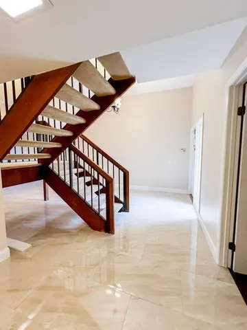 a view of staircase with lots of frames on wall