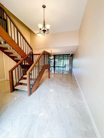 a view of staircase and kitchen with furniture
