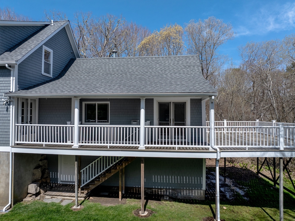 329 Front Street Marion, MA 02738 - Photo 4 of 42 a view of a house with a deck and a yard