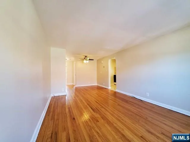 a view of a room with wooden floor