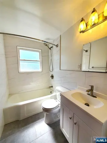 a bathroom with a sink a toilet and bathtub