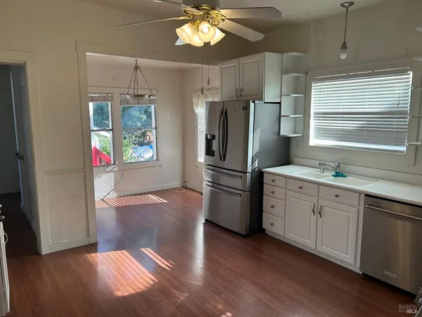 a kitchen with a refrigerator and a sink