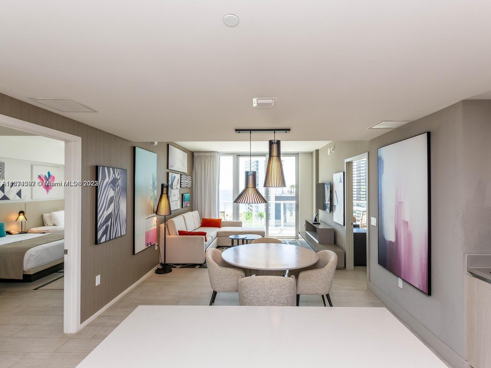 4010 South Ocean Drive, Unit R1005 Hollywood, FL 33019 - Photo 11 of 14 a living room with furniture and a large window