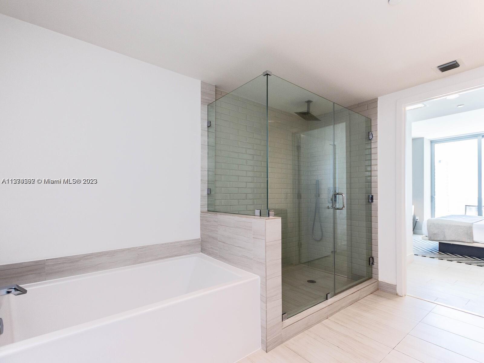 4010 South Ocean Drive, Unit R1005 Hollywood, FL 33019 - Photo 14 of 14 a bathroom with a shower and a tub