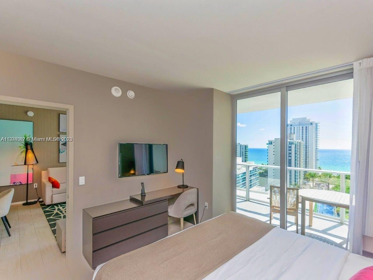 4010 South Ocean Drive, Unit R1005 Hollywood, FL 33019 - Photo 7 of 14 a living room with furniture and a large window