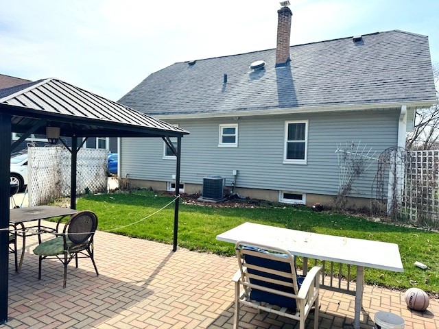 430 Enterprise Street Elgin, IL 60120 - Photo 18 of 18 a front view of a house with a yard table and chairs