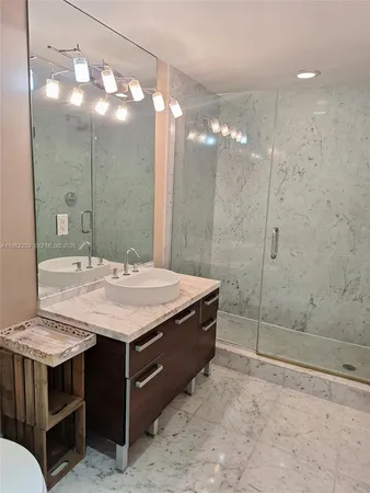 a bathroom with a sink a vanity and a mirror