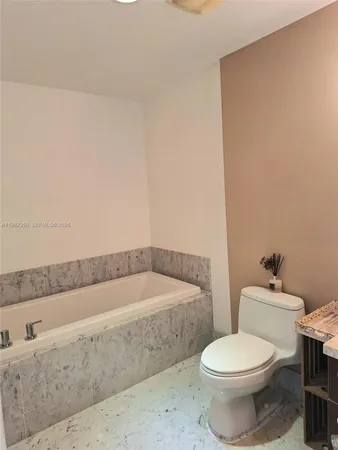 a bathroom with a sink a toilet and bathtub
