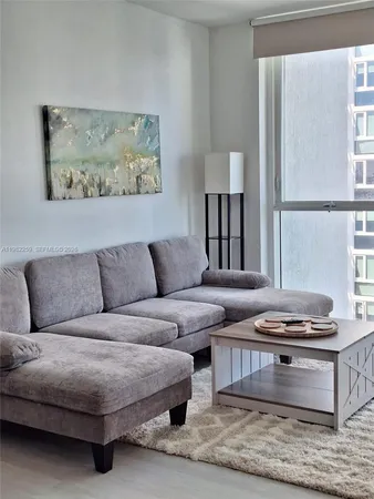 a living room with furniture and a window