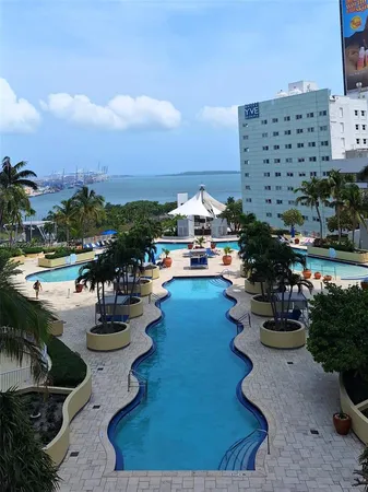a view of swimming pool with outdoor seating and city view