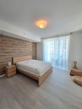 a bedroom with a bed and a lamp with window