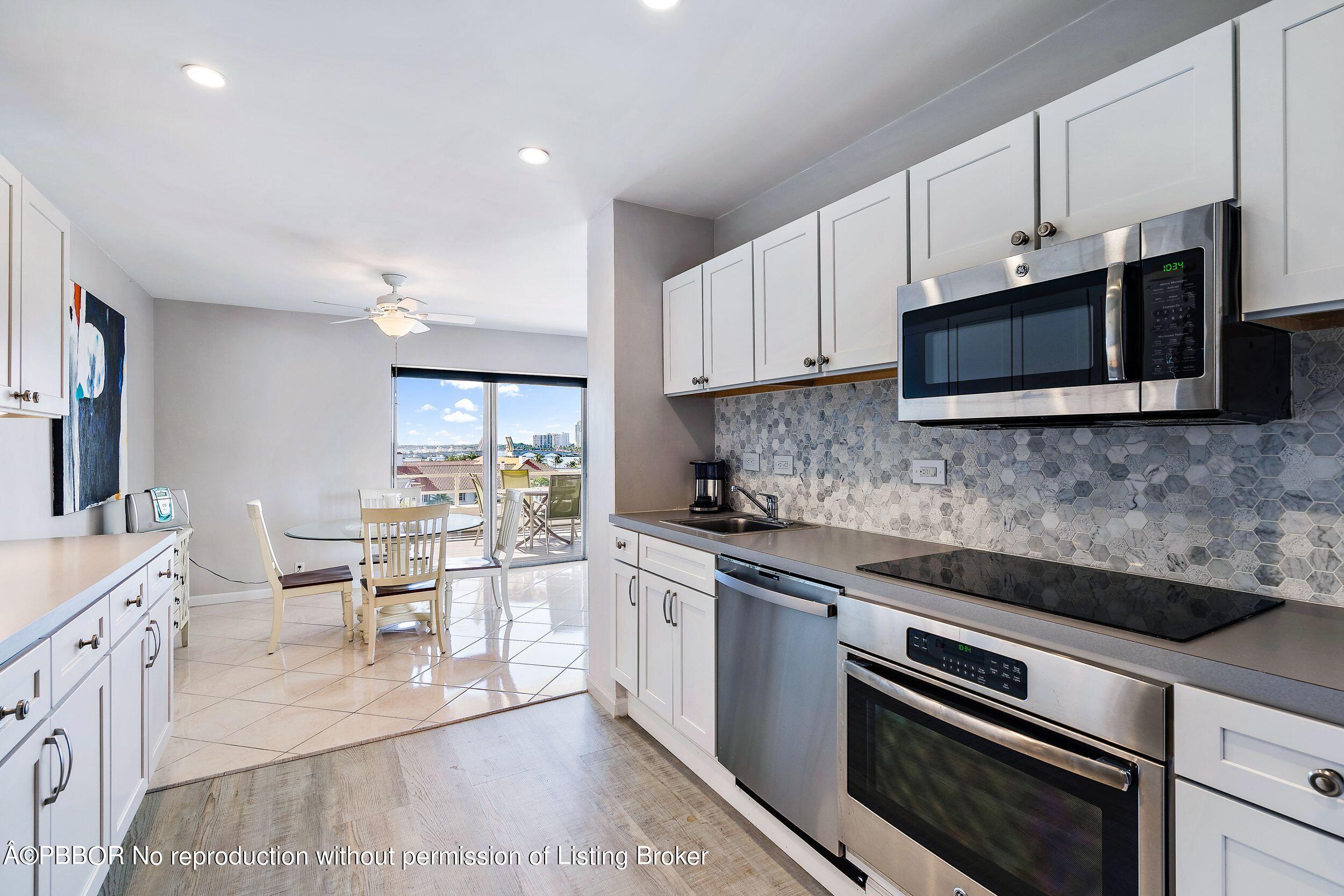 44 Cocoanut Row, Unit 626B Palm Beach, FL 33480 - Photo 5 of 12 a kitchen with stainless steel appliances a stove microwave and sink
