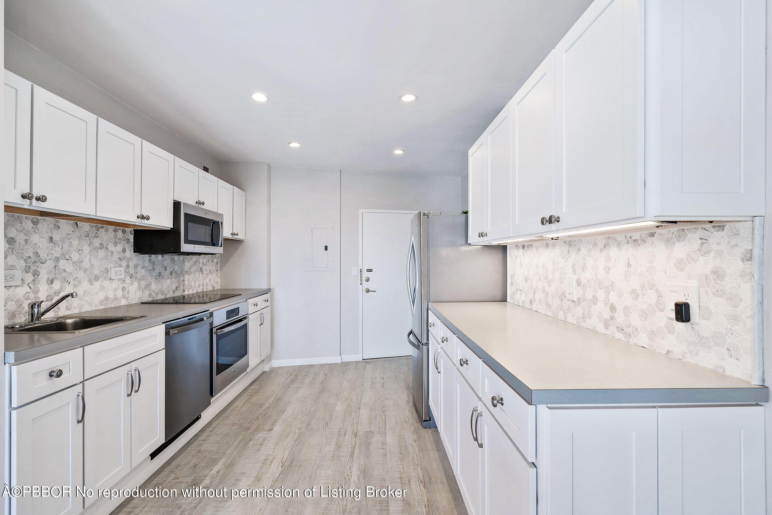 44 Cocoanut Row, Unit 626B Palm Beach, FL 33480 - Photo 7 of 12 a kitchen with a sink stove top oven and cabinets