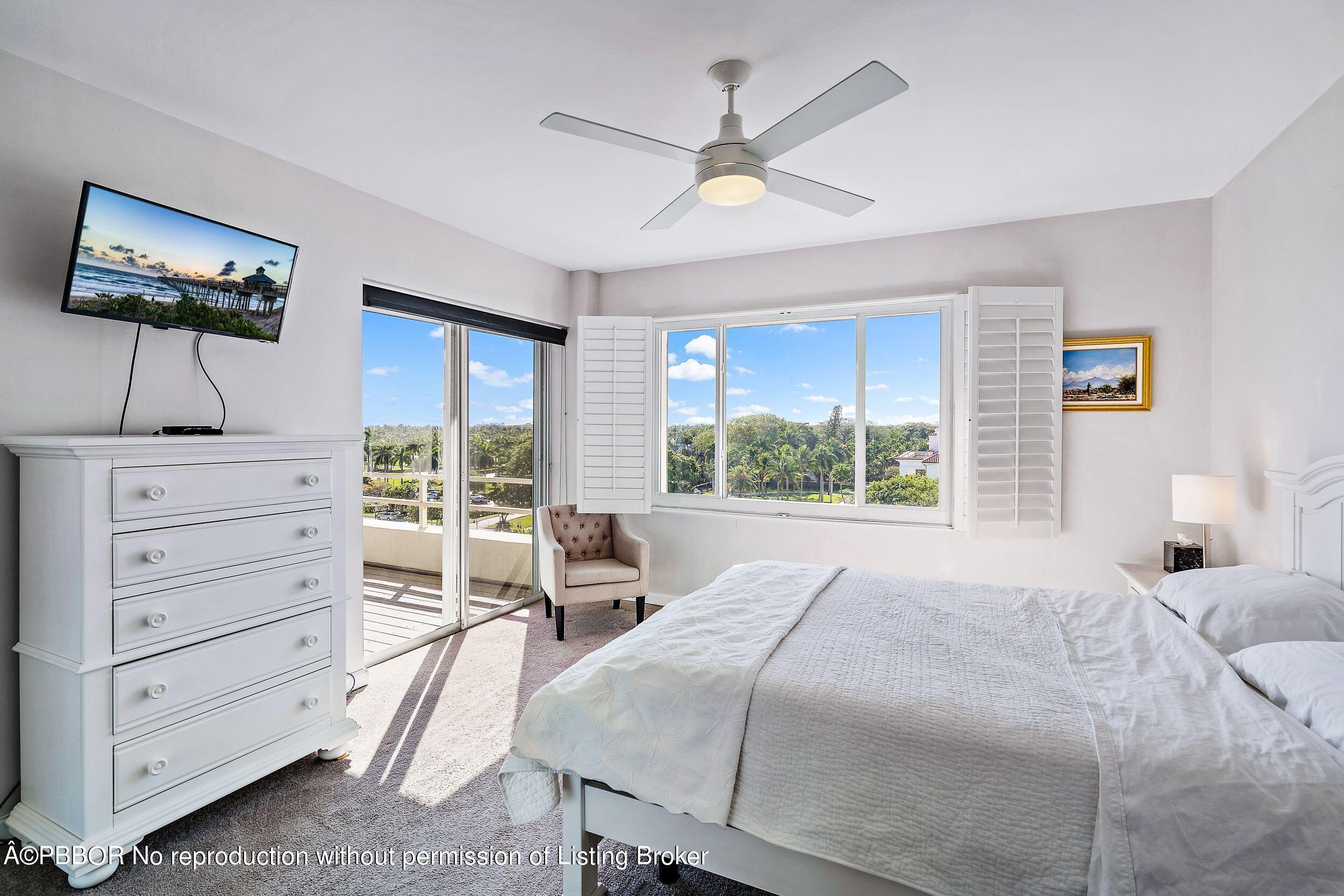 44 Cocoanut Row, Unit 626B Palm Beach, FL 33480 - Photo 9 of 12 a bedroom with a bed a chandelier and a large window