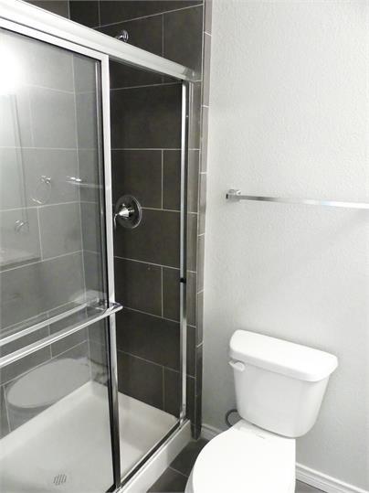 8071 County Road, Unit 436 Princeton, TX 75407 - Photo 4 of 8 a bathroom with a toilet and a shower