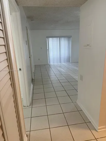 a view of an empty room and a window