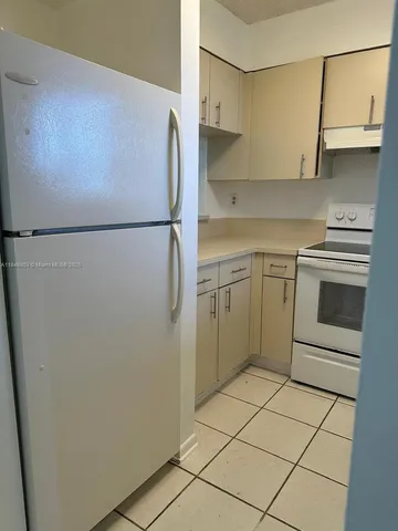 a kitchen with stainless steel appliances a refrigerator sink and cabinets