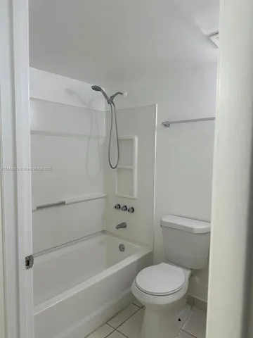 a bathroom with a toilet and a bathtub