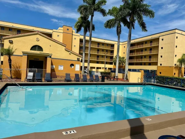 a view of swimming pool with outdoor seating