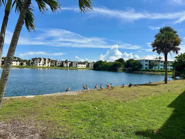 a view of a lake with houses in the back