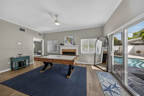 a living room with furniture a table and wooden floor