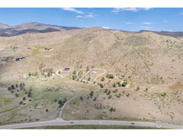a view of a dry yard with mountains in the background